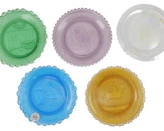 755 - 5 Pairpoint Glass Coasters 3" (Description): Set of five Pairpoint glass coasters  featuring scalloped edges and embossed  decorative designs. The collection includes  green, lavender, clear iridescent, blue, and  amber colored examples, each displaying different motifs including an owl,  pelican,and carousel horse. Each coaster  measures 3 inches in diameter.