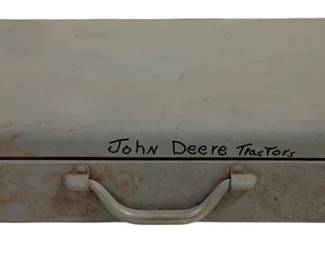 1688 - Vtg Metal Storage Box John Deere Tractors (Description): Vintage metal storage box with hand-written  "John Deere Tractors" inscription on the lid.  This cream or off-white painted metal case  features dual latches, a center carrying  handle, and shows signs of age with some rust patina along the bottom edge. Measures 2  1/2" x 10" x 5".