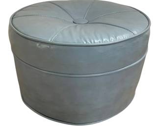 7599 - Mid Century Vinyl Round Footstool (Description): The piece features a padded top with  pie-shaped sectional stitching and piped trim  details around the edges. Measures 12 inches  in height by 17 inches in diameter.