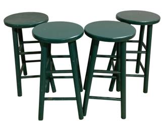 7661 - 4 Green Painted Wood Bar Stools (Description): Featuring saddle-style seats and splayed legs  with stretcher supports. The stools show a  classic country or farmhouse style with  visible wear to the painted finish consistent  with age and use. Each stool measures 28 inches high by 20 inches wide by 16 inches  deep.