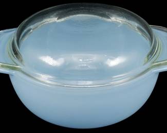 1218 - Pyrex Blue Bowl w/ Clear Glass Lid (Description): Pyrex blue glass bowl with clear glass lid.  The bowl features a delicate powder blue milk  glass construction with two tab handles on  either side. Accompanied by a clear glass  domed lid. Measures 2 1/2" x 5 1/2" x 4".