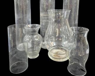 1442 - 5 Glass Vases & 2 Hurricanes 19.5" (Description): A collection of five clear glass vases and  two glass hurricane shades. The tallest piece  measures 19.5 inches.