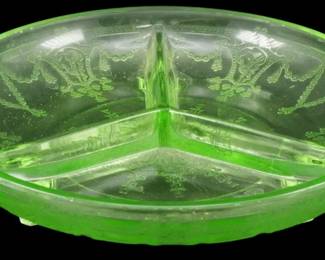 900 - Vtg Anchor Hocking Uranium Cameo Relish Dish (Description): Vintage Anchor Hocking uranium glass relish  dish in the Cameo pattern. This  depression-era divided dish features three  sections with decorative handles on either  side. The green vase line glass displays the classic etched Cameo design with dancing  figures and floral swags. Measures 2 inches  tall by 8 inches in diameter.