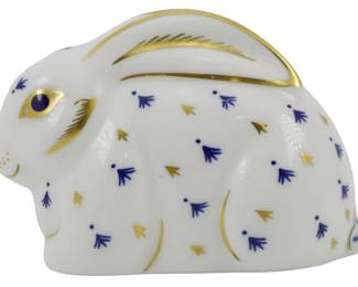 796 - Royal Crown Derby Baby Rabbit Paperweight (Description): Royal Crown Derby baby rabbit paperweight  featuring a white porcelain body decorated  with cobalt blue floral sprigs and gold  accents. The piece has hand-painted gold  detailing on the ears, eyes, and body. Includes the gold stopper, indicating a  first-quality piece. Measures 2 inches.