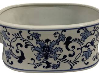 1544 - Blue & White Porcelain Foot Bath Tub 14x9x6 (Description): Blue and white porcelain foot bath tub  featuring traditional scrolling floral and  foliate decoration in the Chinese style. The  oval vessel has a rolled rim with blue band  accents and applied handles on each end. Measures 14 inches by 9 inches by 6 inches.