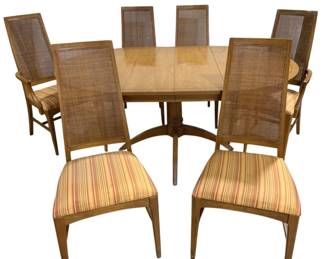7641 - 7 Pc Mid-Century Dining Set w/ Leaves (Description): Has round pedestal table w/ 2 leaves that  have 2 support legs. Dining chairs feature  high cane backs and upholstered seats in a  striped fabric with warm tones of cream,  gold, and red. The set includes two armchairs and four side chairs, all constructed with  warm-toned wood frames and tapered legs  connected by stretchers. Measurements: Table  w/ leaves 30"x68"x44", chairs 42"x14"x17" &  42"x21"x18".