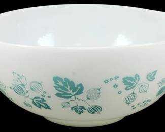1188 - Pyrex Turquoise Gooseberry Mixing Bowl (Description): Pyrex Turquoise Gooseberry medium mixing  bowl. This vintage white milk glass bowl  features the classic turquoise gooseberry  pattern with decorative leaves, berries, and  small star motifs. The bowl has the distinctive Cinderella style with two pouring  spouts on opposite sides. Measures 4 inches  tall by 11 inches wide by 8.5 inches deep.