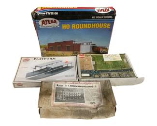 1674 - 4pc Lot HO Scale Model Railroad Building Kits (Description): Collection of four HO scale model railroad  building kits. Includes an Atlas Model  Railroad Co. HO Roundhouse, a Model Power  Platform kit, a Busch Sportplatz Stadium kit,  and an American Model Builders A.C. Brown Manufacturing Co. building kit. All kits are  in their original boxes.