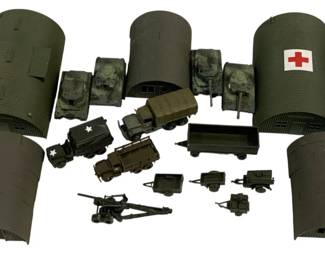 1585 - Lot Assorted Military Vehicles & Buildings (Description): An assorted lot of military vehicles and  buildings. The collection includes olive drab  painted pieces featuring Quonset hut style  buildings, one marked with a Red Cross  medical symbol. Various military vehicles are included such as tanks, covered trucks with  US Army star markings, trailers, an artillery  piece, and other support vehicles. The  pieces appear to be model or diorama scale  military equipment suitable for wargaming or