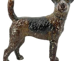 1042 - Cast Iron Terrier Dog Figure 8.5"x7.5"x3.5" (Description): Cast iron dog figure depicting a standing  terrier, likely an Airedale or Wire Fox  Terrier, in an alert pose with tail raised.  The figure features a painted finish in  brown, black, and white tones showing desirable age-related patina and paint wear  consistent with antique cast iron pieces.  Measures 8.5" x 7.5" x 3.5".