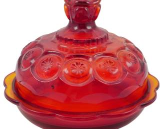 993 - L.E. Smith Amberina Moon & Star Butter Dish (Description): Vintage L.E. Smith Amberina Moon & Star  pattern butter dish. This pressed glass piece  features the classic Moon & Star design with  circular medallions containing star motifs  on the domed lid. The amberina coloring transitions from deep red to amber yellow at  the edges, with a decorative scalloped rim  and rose-shaped finial on the lid. Measures  6" x 7".