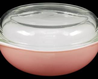 1217 - Pyrex Flamingo Pink Lidded Casserole (Description): Pyrex Flamingo Pink lidded casserole dish  featuring the classic mid-century pink  exterior with white interior. Includes the  original clear glass lid with knob handle.  Measures 5 inches by 10 inches by 9 inches.
