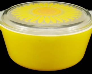 1162 - Pyrex Sunflower 2.5 Quart Casserole w/ Lid (Description): Vintage Pyrex Sunflower pattern 2 1/2 quart  casserole dish with matching lid. The  casserole features a bright yellow body with  two tab handles, accompanied by a clear glass  lid decorated with a bold yellow and orange sunflower design. A cheerful example of  mid-century Pyrex kitchenware. Measures 4" x  11" x 9".