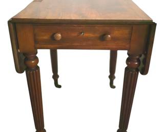 7761 - Sheraton Drop Leaf Table w/ Drawer & Key (Description): Antique mahogany drop leaf side table  featuring elegant turned and reeded legs  terminating in brass casters. The table  exhibits classic Sheraton or Regency styling  with well-figured mahogany throughout. When leaves are raised, the table extends to a  generous surface. Measures 28 inches high by  38 inches wide by 22 inches deep.
