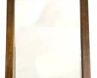 7589 - Mid Century Walnut Frame Wall Mirror By Dixie (Description): Mid-century modern wall mirror featuring a  walnut frame with distinctive geometric block  detailing along the upper portion. The  rectangular mirror has a beveled edge and  clean lines characteristic of the era. Measures 52 inches tall by 29 inches wide.
