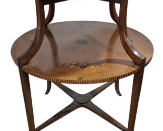 7756 - Satinwood 2 Tier Tea Table w/ Tray & Floral Design (Description): Antique two-tier round tea table featuring  elegant floral decoration. The table is  crafted from mahogany and satinwood. Has  removable framed glass tray with brass  handles. Supported by four gracefully curved splayed legs connected by an X-shaped  stretcher with a central medallion. Measures  32 inches in height by 27 inches in diameter.