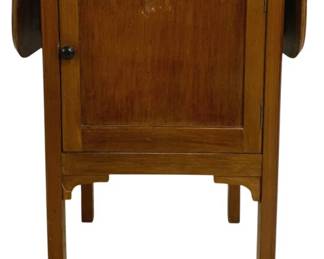 7767 - Vintage English Smoking Stand w/ Cabinet (Description): Vintage wooden smoke stand featuring a single  cabinet door with a round black knob. The  piece has a drop-leaf top design with shaped  edges and stands on four straight legs with  simple bracket details. The warm medium-toned wood shows traditional craftsmanship.  Measures 27" x 32" x 15".