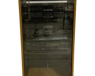 7684 - Sony Stereo System w/ Oak Cabinet 40"x16"x19" (Description): Sony stereo system housed in an oak cabinet  with smoked glass door. The system includes  multiple Sony components including a  receiver, equalizer, dual cassette deck, and  CD player. The cabinet features a warm oak finish with a hinged glass front panel that  provides easy access to all components.  Measures 40 inches tall by 16 inches wide by  19 inches deep. Used as is electric/electronic/mechanical