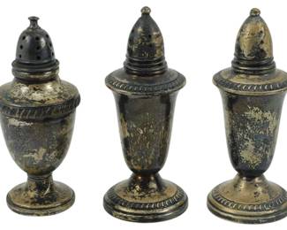 774 - 3 Weighted Sterling Silver Shakers 7.85oz (Description): Three weighted sterling silver shakers with a  combined total weight of 7.85 ounces. The  set features urn-form bodies with classical  styling, including gadrooned borders and  domed pierced tops. The shakers display a heavily tarnished patina consistent with age.