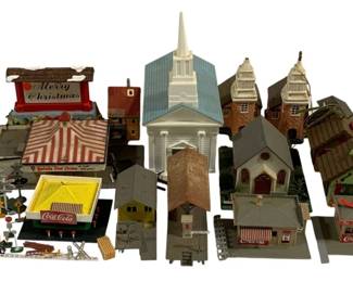 1043 - Assorted Decorative Train Items (Description): A lot of assorted decorative train items.  This collection includes various miniature  buildings and accessories suitable for model  train layouts, featuring structures such as  churches, houses, storefronts, and assorted scenic elements.