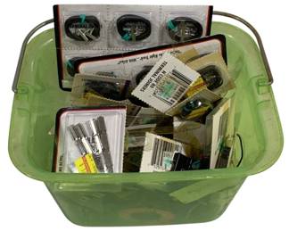 1602 - Plastic Tub of Assorted Model Train Parts (Description): A plastic tub containing assorted model train  parts and accessories. The collection  includes various terminal joiners, track  connectors, and other railroad modeling  components, many still in original packaging. Items appear to be N scale gauge parts  suitable for model railroad enthusiasts and  hobbyists.