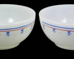 1136 - Set of 4 Termocrisa Red & Blue Floral Bowls (Description): Set of four Termocrisa milk glass bowls  featuring a decorative pattern with red and  blue horizontal bands near the rim and blue  floral tulip motifs around the exterior. The  bowls have a classic mid-century design with a slightly footed base. Each bowl measures 2  inches tall by 5 inches in diameter.