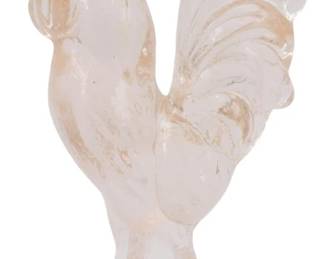 1051 - Pink Glass Rooster Figure 4.5" (Description): Pink glass rooster figure featuring a  decorative standing pose with detailed tail  feathers and comb. The piece has a soft pink  translucent coloring with subtle variations  throughout. Measures 4.5 inches tall.