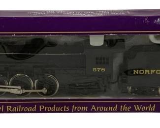 1603 - IHC Norfolk and Western Locomotive w/ Car (Description): IHC Norfolk and Western locomotive with coal  car, part of the Premier Series collection.  This HO scale model features locomotive  number 578 in the classic Norfolk and Western  black livery with gold lettering. The set comes in its original purple display box from  IHC, marketed as 'The Finest Scale Model  Railroad Products from Around the World.'