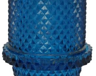 869 - Viking Bluenique Diamond Point Fairy Lamp (Description): Vintage Viking Bluenique diamond point fairy  lamp in deep blue glass. This two-piece lamp  features the distinctive hobnail diamond  point pattern throughout the base and shade,  with a footed pedestal base. The translucent blue glass showcases the geometric texture  beautifully. Measures 7 inches tall.