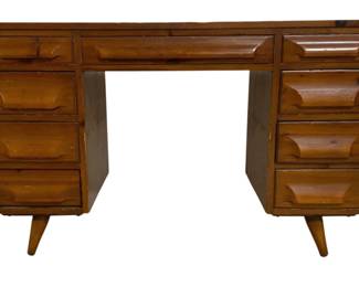 7588 - Franklin Shockey Mid-Century Pine Desk (Description): Featuring twin pedestals with four drawers  each and a center drawer. The desk has  characteristic splayed tapered legs and  sculpted drawer fronts typical of the era.  The warm honey-toned pine shows natural wear consistent with age. Measures 30 inches high  by 48 inches wide by 20 inches deep.