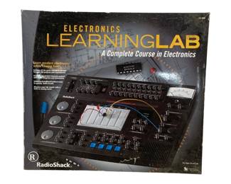 1687 - Radio Shack Electronics Learning Lab Kit (Description): Radio Shack Electronics Learning Lab, a  complete course in electronics. This  educational kit features a breadboard for  building circuits, various knobs and  controls, built-in analog meters, and includes parts and wires needed for over 200  projects and experiments. The solderless  breadboard makes it easy to quickly build  circuits. Designed for ages 10 and up. Box  shows some wear.