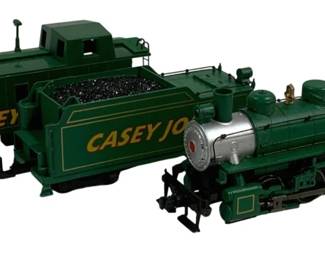 1601 - 3pc HO Scale Casey Jones Train Car Set (Description): Three-piece HO scale Casey Jones train car  set featuring a green steam locomotive with  red cab roof numbered 382, a matching green  coal tender, and a coordinating caboose. Each  piece displays the Casey Jones name in yellow lettering with gold trim accents  throughout.