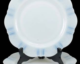 928 - 2 Monax American Sweetheart Plates 9.5" (Description): Two Monax American Sweetheart plates  measuring 9.5 inches in diameter. These  Depression-era plates feature the classic  American Sweetheart pattern with a scalloped  edge and delicate embossed floral design on the rim. The translucent white Monax glass  displays the characteristic subtle blue  opalescent tint at the edges, a hallmark of  this beloved MacBeth-Evans Glass Company  pattern from the 1930s.