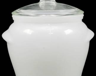 1125 - Glassbake Milk Glass Jar w/ Clear Lid 4.5" (Description): Vintage Glassbake jar in milk glass with a  clear glass lid featuring a knob finial. The  jar has a classic bean pot shape with small  tab handles on the sides. Measures 4.5  inches.