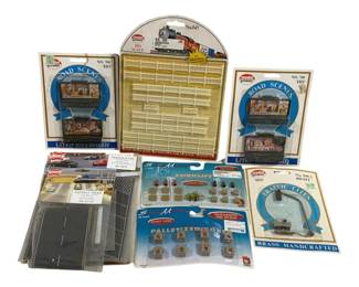 1698 - Lot of HO Scale Train Layout Accessories (Description): A collection of HO scale train layout  accessories including Model Power Road Scenes  lighted billboards, Model Power fencing set  No. 547, Model Power brass handcrafted  traffic lights, Busch asphalt road sections and parking lot, and Scale Master authentic  HO scale palletized boxes and forklift  accessories. Items remain in original retail  packaging.