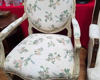 French Louis XVI style fauteuil armchair features an elegant, carved oval (medallion) backrest and a floral-patterned upholstered seat