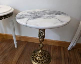 vintage Hollywood Regency-style side table featuring an intricately pierced or reticulated brass filigree base and a round, white marble top
