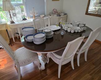 Beautiful dining room table with two expansion leaves and a glass top over the wooden top.