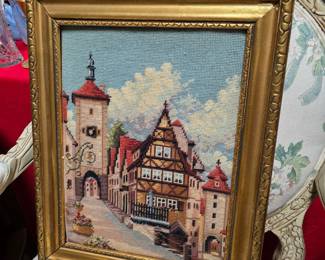 vintage cross-stitch tapestry depicting "Das Plönlein," a famously picturesque timber-framed corner and clock tower in the historic town of Rothenburg ob der Tauber, Germany.