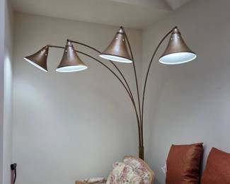 Arc floor lamp with four curved arms and distinct, cone-shaped mica shades.