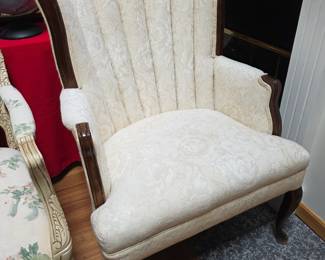 vintage Queen Anne style accent chair features a classic channel-tufted back, elegant cabriole legs, and wood-trimmed arms in a cream damask fabric.