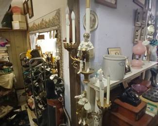 Tension pole lamp adorned with Cherubs