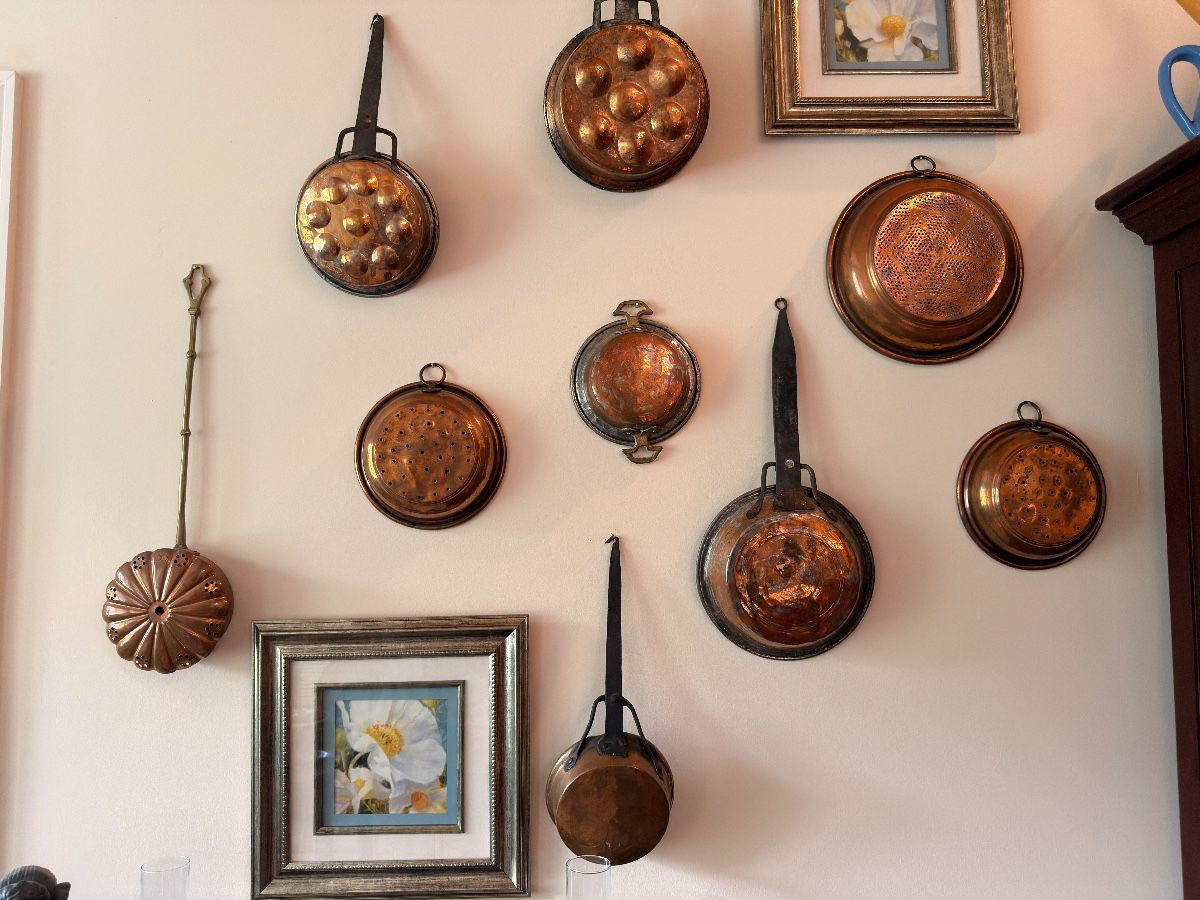 Vintage copper pots, pans and molds wall collection