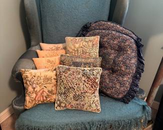 Wingback chair with tapestry throw pillows