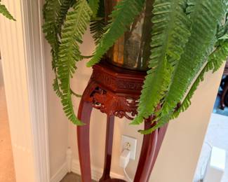Carved mahogany plant stand with fern