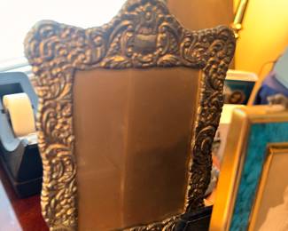 Ornate repousse metal frame vanity mirror