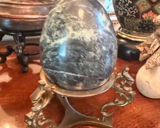 Polished marble egg on brass stand