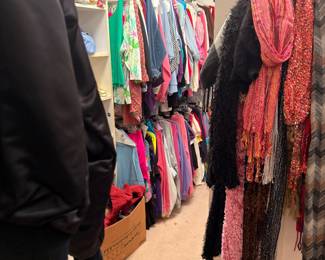 Racks of colorful clothing and fashion scarves