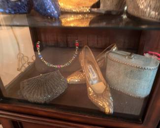 Gold heels, train case and rhinestone necklace