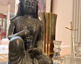 Carved stone Quan Yin statue and crystal candlesticks